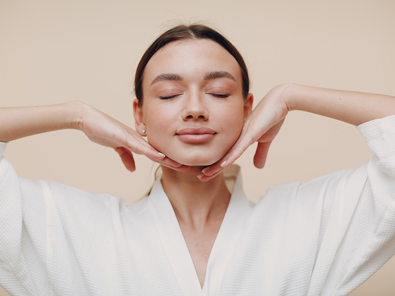 Woman holding face and smiling